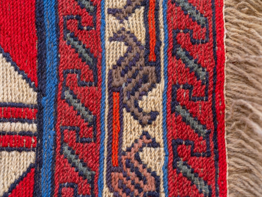 A close up of a red and blue rug