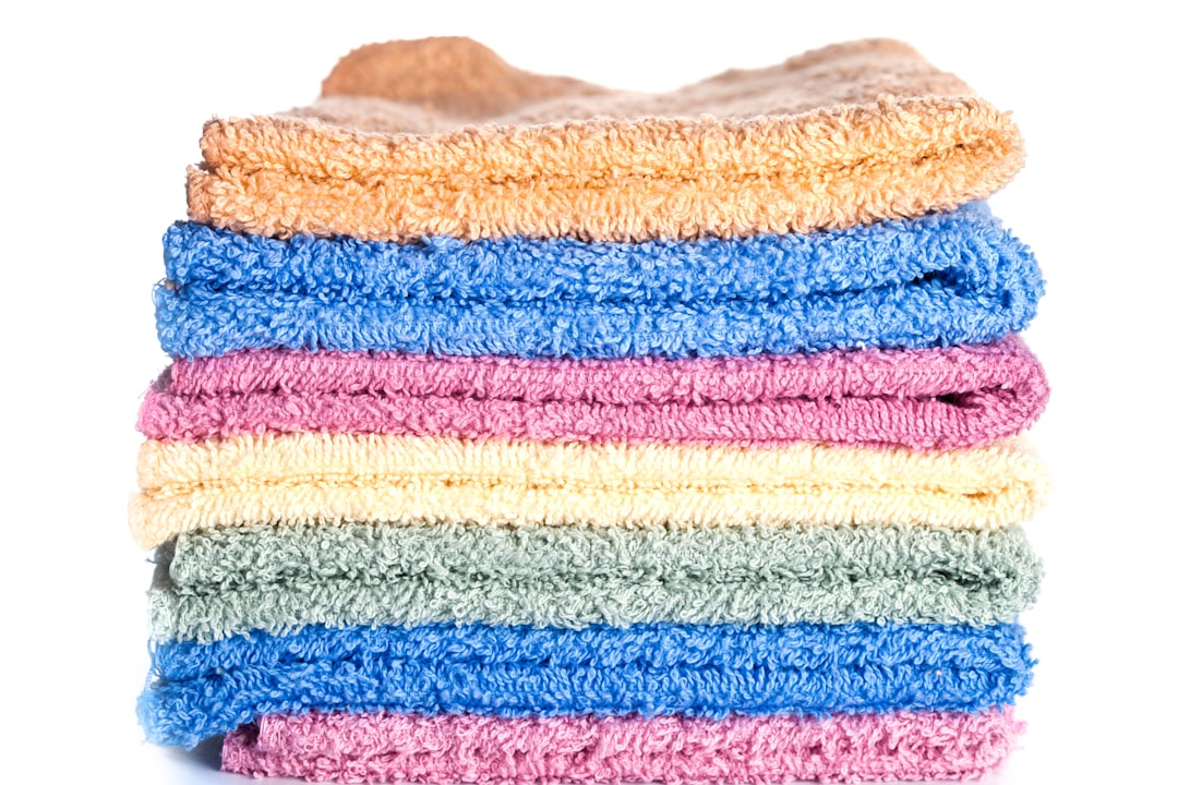 A stack of multicolored towels on a white background